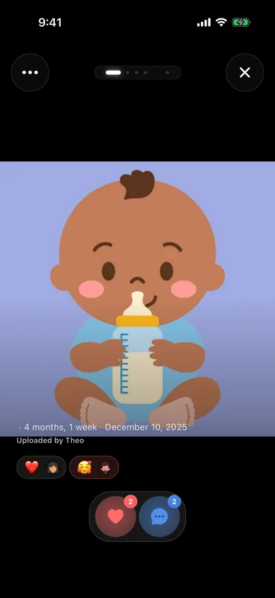 Clann photo opened in Simple view showing a baby illustration, the age 4 months and 1 week, the date, the uploader, existing reactions, and an action bar with only a heart and a comment button.